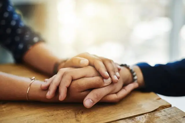 a close up of hands holding each other