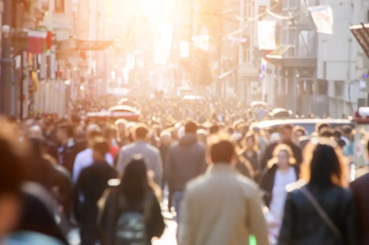 a crowd of people walking on a street