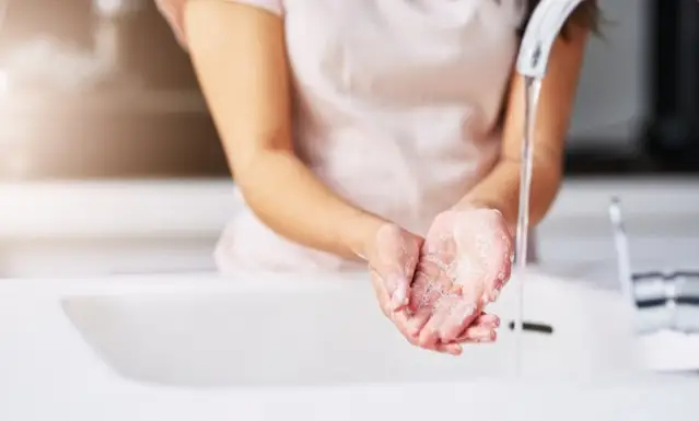 a person washing their hands