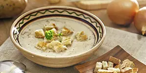 a bowl of soup with croutons on it