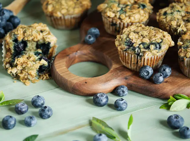 muffins with oatmeal and blueberries on a wooden board