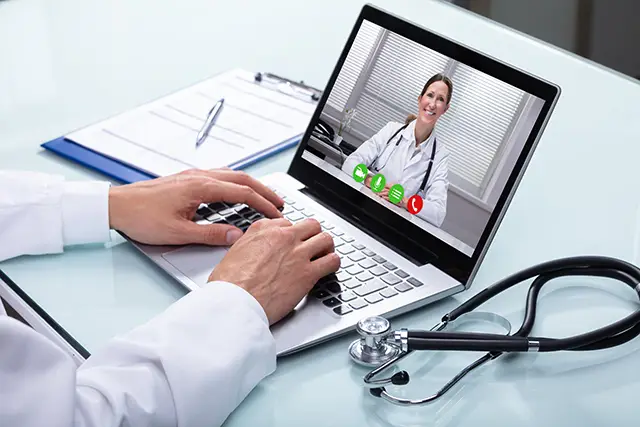 a doctor using a laptop
