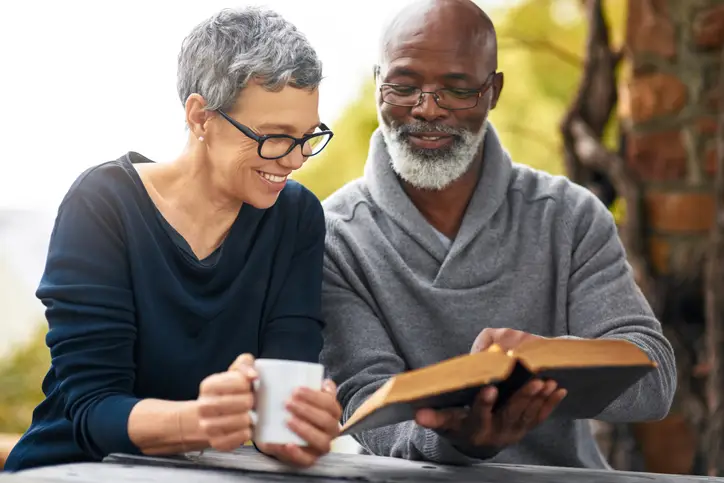 a man and woman reading a book