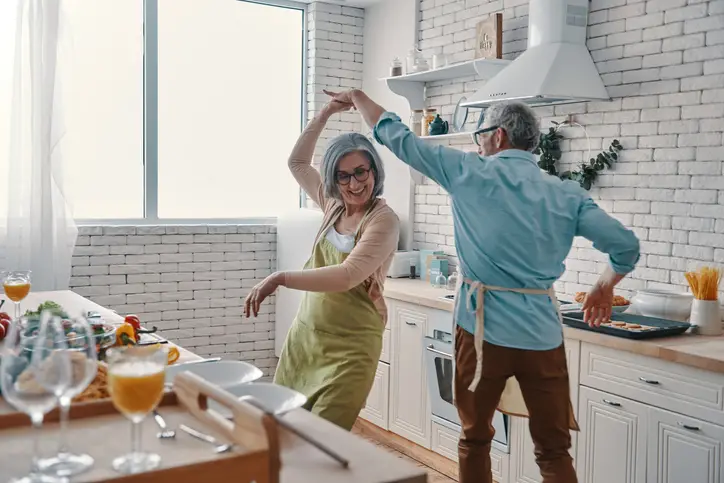 a man and woman dancing in a kitchen
