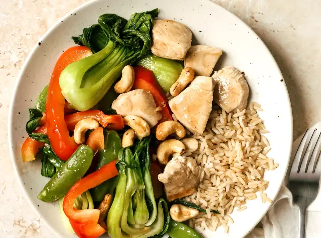 Cashew chicken with snap peas, red bell pepper, and bok choy