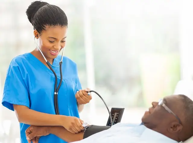 a nurse checking a patient's blood pressure