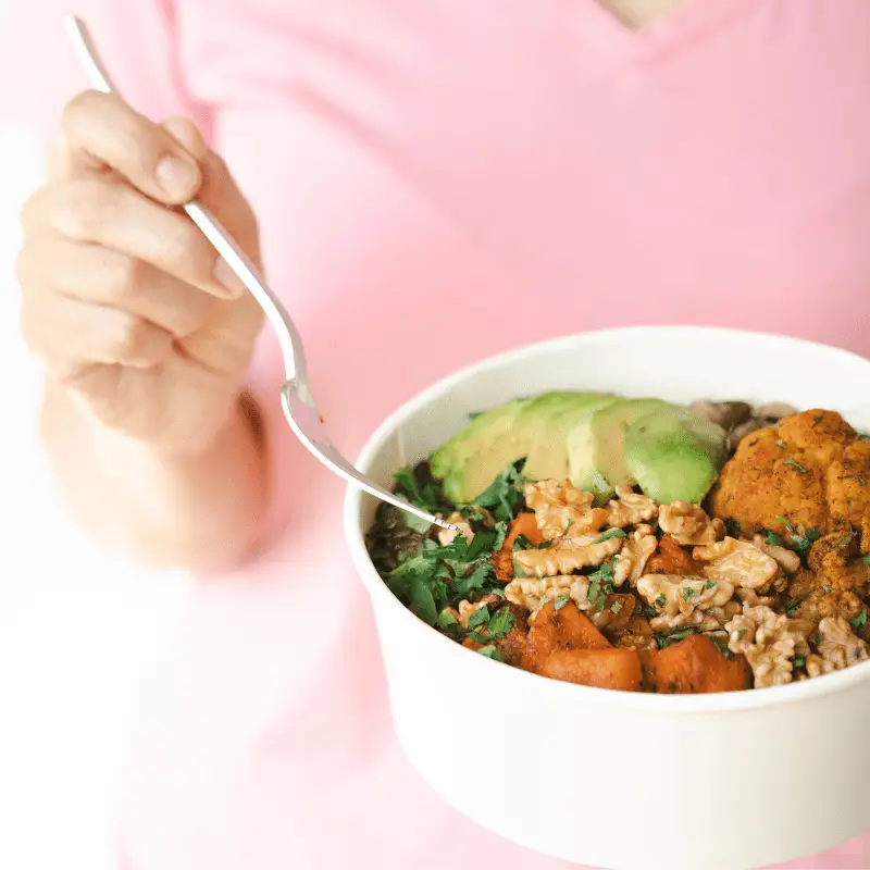 a person holding a bowl of food